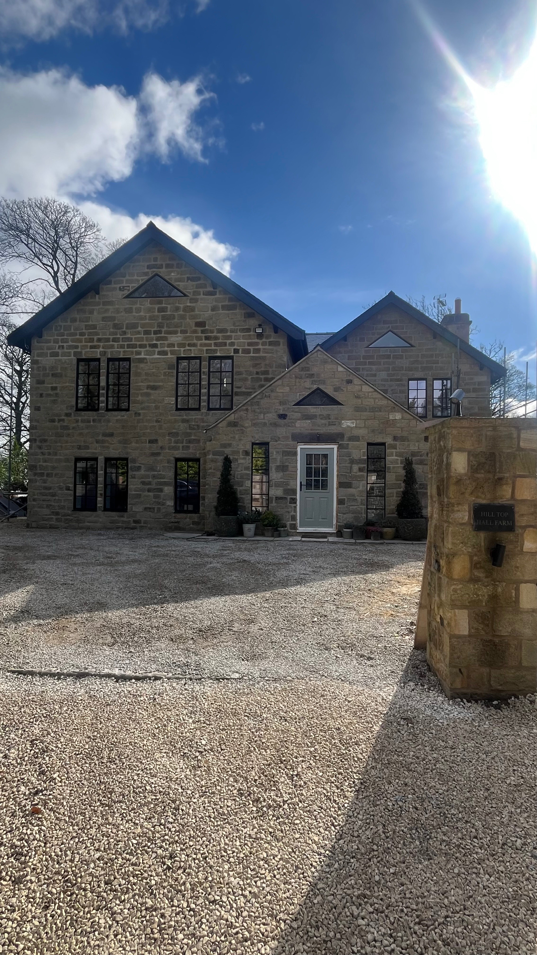 Front elevation — Heritage windows and entrance door across the full stone façade