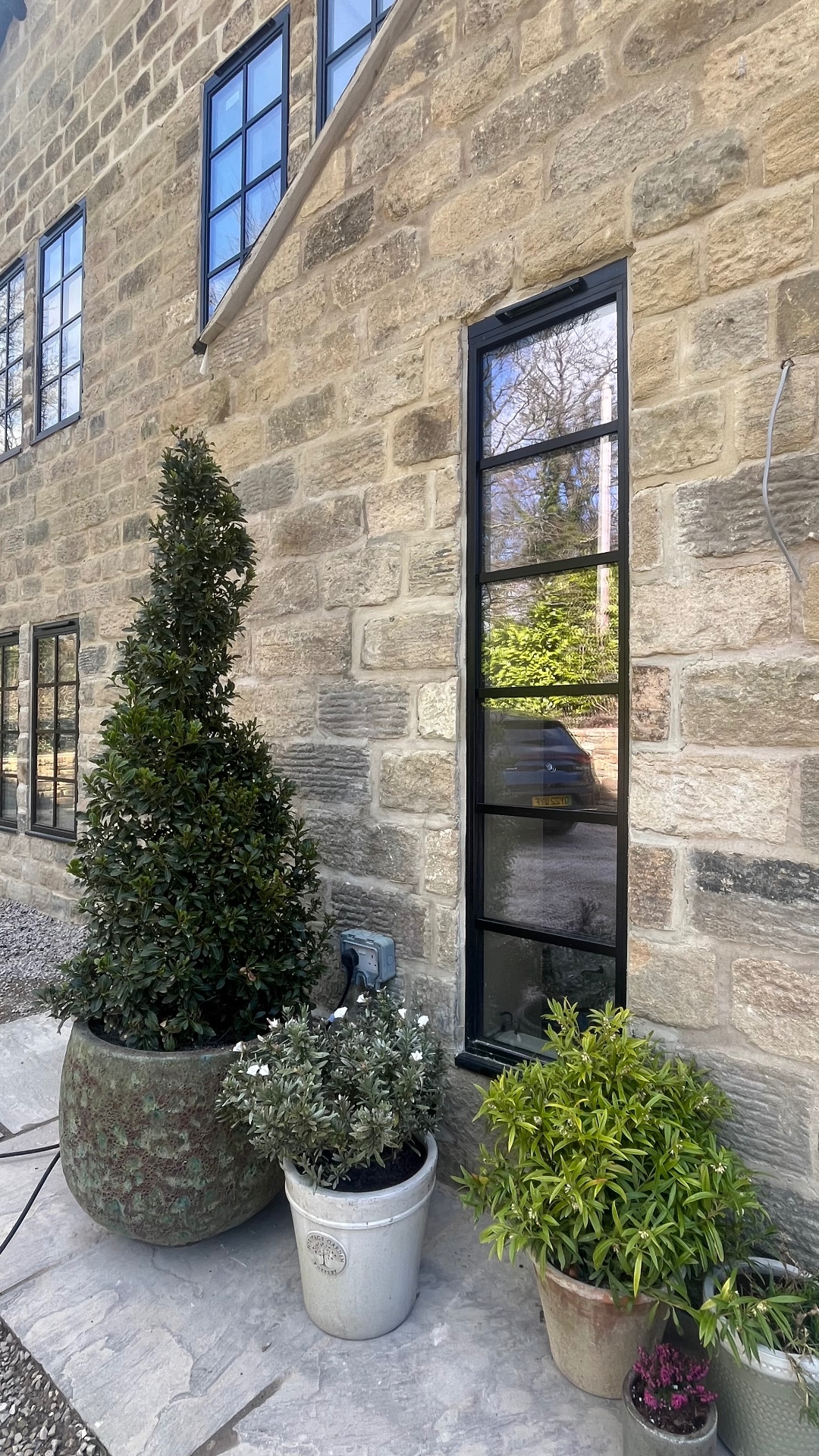 Full-height narrow Heritage light beside the rear entrance